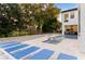 Resort-style pool with tanning chairs and outdoor kitchen area overlooking a lush green area at 7465 Gathering Loop, Reunion, FL 34747