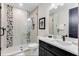 Modern bathroom featuring a glass shower with black and white tile accent wall at 7465 Gathering Loop, Reunion, FL 34747