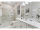 Bright bathroom with a glass-enclosed shower, white vanity, and modern fixtures at 7465 Gathering Loop, Reunion, FL 34747