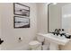 Powder room featuring black and white decor and pedestal sink at 7465 Gathering Loop, Reunion, FL 34747