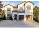 Stunning two-story home with a symmetrical facade, a paver driveway, and a two-car garage at 7465 Gathering Loop, Reunion, FL 34747