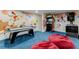 Spacious game room featuring cartoon wall art, arcade games and comfortable seating at 7465 Gathering Loop, Reunion, FL 34747