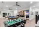 Spacious game room featuring a pool table, foosball, wet bar, and plenty of room for entertainment at 7465 Gathering Loop, Reunion, FL 34747