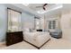 Serene main bedroom with soft blue accents, large windows, and neutral decor at 7465 Gathering Loop, Reunion, FL 34747