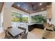 Outdoor kitchen and dining area with a built-in grill, bar seating, and a view of the swimming pool at 7465 Gathering Loop, Reunion, FL 34747