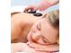 Close-up of a relaxing spa treatment with hot stones on a person's back at 7465 Gathering Loop, Reunion, FL 34747