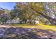 Spacious backyard with large trees, lush grass, and a white fence at 762 Lake Como Dr, Lake Mary, FL 32746