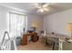 Neutral-toned bedroom with a large window, ceiling fan, carpeted floors, and various furnishings at 762 Lake Como Dr, Lake Mary, FL 32746