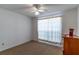 Bedroom with a ceiling fan, carpeted floors, window with curtains, and dresser at 762 Lake Como Dr, Lake Mary, FL 32746