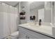 Bathroom featuring a white shower curtain, neutral towels, a white vanity, and gray walls at 7671 Otterspool St, Kissimmee, FL 34747