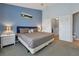 Bedroom featuring carpet floors, a cozy bed, and ample natural light, creating a serene and inviting space at 7671 Otterspool St, Kissimmee, FL 34747