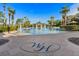 A beautiful resort-style zero-entry pool area with palm trees, shade structures, and decorative WH logo at 7671 Otterspool St, Kissimmee, FL 34747