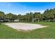 Exterior view of the sand volleyball court with a grassy perimeter and shady gazebo at 7671 Otterspool St, Kissimmee, FL 34747