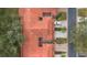 Birds eye view of red tile roofs and driveways with manicured lawns and shrubbery at 7709 Sundial Ln, Orlando, FL 32819