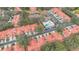 This aerial shows the property's neighborhood and the amenities offered: pool, tennis court and clubhouse at 7709 Sundial Ln, Orlando, FL 32819