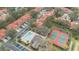 Aerial view showcases community amenities: a pool, clubhouse, and tennis courts at 7709 Sundial Ln, Orlando, FL 32819