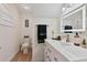 A well-lit bathroom with a modern sink, a decorative mirror, and wood-look flooring at 7709 Sundial Ln, Orlando, FL 32819