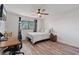 Bedroom with a desk, wood floors, and a window with natural light at 7709 Sundial Ln, Orlando, FL 32819