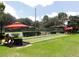 Scenic view of community bocce ball court with benches, landscaping, and shaded seating at 7709 Sundial Ln, Orlando, FL 32819