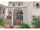 The courtyard features a decorative wrought-iron gate, brick-paved walkway, stucco walls, and lush landscaping at 7709 Sundial Ln, Orlando, FL 32819