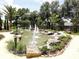 Beautiful water fountain surrounded by lush landscaping, creating a serene and inviting outdoor space at 7709 Sundial Ln, Orlando, FL 32819