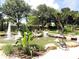 Beautiful water fountain with statue surrounded by lush landscaping, creating a serene and inviting outdoor space at 7709 Sundial Ln, Orlando, FL 32819