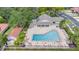 Aerial view of a blue community pool area with lounge chairs and umbrellas at 7709 Sundial Ln, Orlando, FL 32819