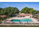 Aerial view of a community pool with lounge chairs and umbrellas on a sunny day at 7709 Sundial Ln, Orlando, FL 32819