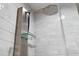 A modern shower with sleek fixtures, including a rainfall shower head and integrated shelving at 7709 Sundial Ln, Orlando, FL 32819