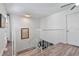 Upstairs hallway features neutral walls, wood floors, and a white railing at 7709 Sundial Ln, Orlando, FL 32819