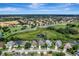 Overhead view of a neighborhood showcases the property's location near a green space and community features at 7916 Golden Pond Cir, Kissimmee, FL 34747