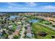 Picturesque aerial scene of a community with lakes, a fountain, and diverse residential architecture at 7916 Golden Pond Cir, Kissimmee, FL 34747