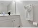 Bathroom featuring a single vanity with white cabinet doors and a decorative towel on a rack at 7916 Golden Pond Cir, Kissimmee, FL 34747