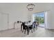 Elegant dining room with a modern chandelier, seating for six, and sliding glass doors leading to the outdoor area at 7916 Golden Pond Cir, Kissimmee, FL 34747