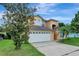 Charming two-story home showcasing a well-maintained lawn, driveway, and an attached two-car garage at 7916 Golden Pond Cir, Kissimmee, FL 34747