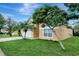 Charming, light yellow two-story home featuring a two-car garage, well-maintained lawn, and lush landscaping at 7916 Golden Pond Cir, Kissimmee, FL 34747