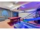 Garage featuring a pool table, an air hockey table and Star Wars themed decor, for entertainment at 7916 Golden Pond Cir, Kissimmee, FL 34747