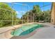 Sparkling pool area featuring a screen enclosure, creating a refreshing oasis surrounded by mature trees at 7916 Golden Pond Cir, Kissimmee, FL 34747