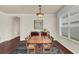 Dining area with hardwood floors, a wooden table, and window with blinds at 8044 Saint James Way, Mount Dora, FL 32757