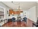 Open dining area showcasing hardwood floors, chandelier lighting, and a seamless transition into the kitchen at 8044 Saint James Way, Mount Dora, FL 32757