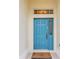 Inviting blue front door with sidelight and transom window, and a welcome mat at 8044 Saint James Way, Mount Dora, FL 32757