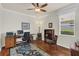 Office space featuring hardwood floors, a ceiling fan, natural light, and a wood desk at 8044 Saint James Way, Mount Dora, FL 32757