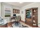 Bright office space featuring a wood desk, a classic book shelf, and a window that provides natural light at 8044 Saint James Way, Mount Dora, FL 32757