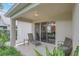 Relaxing covered patio with comfortable seating and sliding glass doors leading to the living area at 8044 Saint James Way, Mount Dora, FL 32757