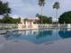 Inviting swimming pool surrounded by lounge chairs and lush landscaping at 8044 Saint James Way, Mount Dora, FL 32757