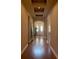 Inviting hallway featuring hardwood floors, archways, and a double-door entryway with transom windows at 8908 Via Bella Notte, Orlando, FL 32836