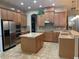 Spacious kitchen with stainless steel appliances, granite countertops, and a functional center island at 8908 Via Bella Notte, Orlando, FL 32836