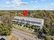 Aerial view of gray townhomes surrounded by lush greenery, showcasing the neighborhood at 945 N Fern Creek Ave, Orlando, FL 32803