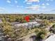 Scenic aerial view of a townhome complex nestled among trees, with blue sky overhead at 945 N Fern Creek Ave, Orlando, FL 32803