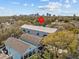 Aerial view of townhomes amidst greenery, cityscape visible in the distance at 945 N Fern Creek Ave, Orlando, FL 32803